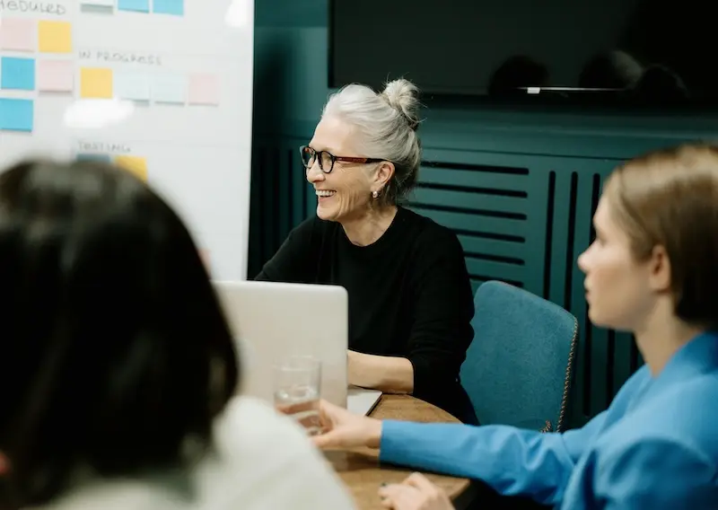Reliable, ongoing support tailored to your business needs. A diverse team of three women collaborating at a table, symbolizing ongoing business support and teamwork.